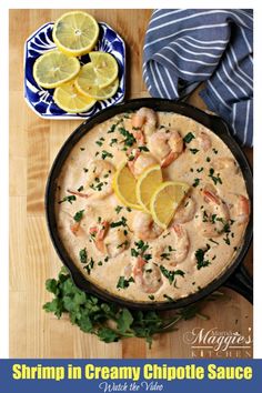 shrimp in creamy chipotie sauce with lemons and parsley on the side