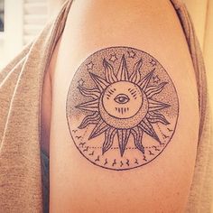 a woman with a sun tattoo on her arm