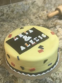 a yellow cake with black and white frosting