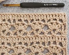 the crochet pattern is next to a knitting needle