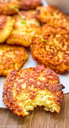 several crab cakes on a wooden cutting board