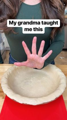 a woman holding her hand out in front of a pie pan with the words, my grandma taught me this