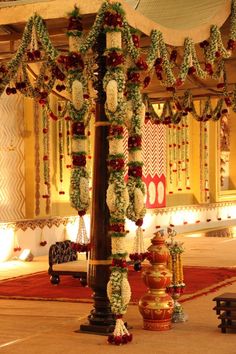 an elaborately decorated pole in the middle of a room with lights and decorations on it