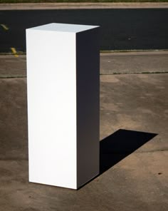 a tall white object sitting on top of a parking lot