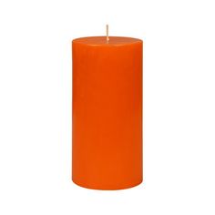 an orange pillar candle on a white background