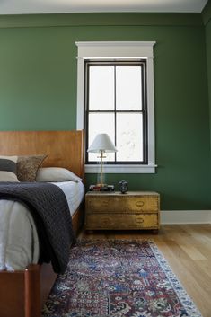 a bed sitting next to a window in a bedroom