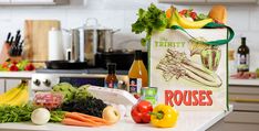 a grocery bag sitting on top of a kitchen counter filled with vegetables and other items