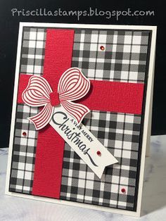 a handmade christmas card with a red ribbon