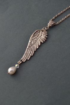 PLEASE read my shop announcement before placing an order so you know what to expect right now. Plus, when ordering from outside Europe, don't forget to provide a phone number for the courier to ensure the fastest and smoothest delivery. Romantic silver angel wing necklace with a pearl drop. Dainty and beautiful! Short necklace with a wing pendant in a stainless steel chain, so it won't rust, and a crystal pearl drop hanging from the detailed, beautiful wing pendant. Chain is about 40/42 cm, 16,5 Elegant Angel Wings Pendant Jewelry, Elegant Jewelry Pendant With Angel Wings, Elegant Nickel-free Wing-shaped Jewelry, Angel Wings Jewelry, Wing Jewelry, Silver Angel Wings, Angel Wing Necklace, Pearl Drop Necklace, Silver Pearl Necklace