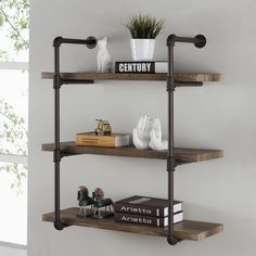 three shelves with books and vases on them