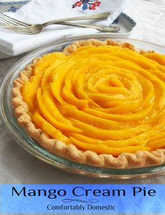 a close up of a pie on a plate with a fork and napkin in the background