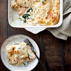 a casserole dish with spinach and salmon in it next to a fork