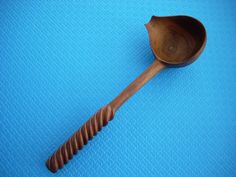 a wooden spoon sitting on top of a blue surface