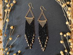 Sparkly fringe earrings in neutral colors Color: black with golden fire-polished glass beads For these beaded fringe earrings I used Charlotte beads, which are characterized by their flat cut sides and therefore make them extra sparkly in the light. The fringe is very flexible and mobile because of the very fine beading thread that was used to weave these earrings and each strand end is decorated with fire-polished Czech beads. The neutral color scheme and the playful combination of brass chains Black Beaded Fringe Tassel Earrings As Gift, Elegant Black Beaded Fringe Chandelier Earrings, Black Beaded Fringe Earrings As Gift, Black Beaded Fringe Earrings For Party, Party Black Beaded Fringe Earrings, Black Beaded Fringe Tassel Earrings For Party, Elegant Black Beaded Earrings With Fringe, Beaded Fringe Earrings, Beading Thread