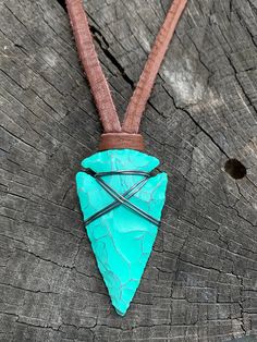 "This is my fresh spin on a wire wrapped classic. Arrowheads have been worn as jewelry for ages and are a recognizable symbol of alertness, walking the straight and narrow & strength. The arrowhead I used is made of jasper stone and is a hand knapped modern replica. It was made in the same tradition and with the same primitive techniques that early man used. I added a lovely deep green turquoise patina and wire wrapped it with blackened (oxidized) copper wire. This is a great unisex design a Hand Wrapped Turquoise Jewelry For Festivals, Turquoise Hand Wrapped Jewelry For Festivals, Adjustable Green Rustic Necklace, Adjustable Rustic Green Necklace, Rustic Green Adjustable Jewelry, Rustic Turquoise Jewelry For Festivals, Spiritual Adjustable Turquoise Necklace Gift, Adjustable Bohemian Jewelry For Outdoors, Adjustable Bohemian Jewelry For Outdoor