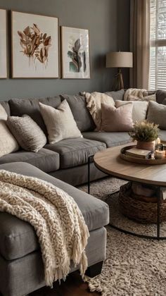 a living room filled with lots of furniture and pillows on top of a rug in front of a window