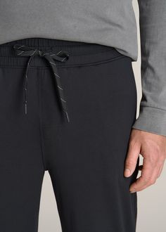 About Our Weekender Stretch Lounge Joggers for Tall Men We’re proud to introduce you to the tall men’s jogger pants you’ll never want to take off. Casual, flexible, and smooth on the skin, these bottoms are a weekend essential. They feature an easy pull-on elastic waist with an external drawstring so you can find your perfect fit. The ornamental fly adds classic style to these extra-long men’s joggers. Designed specifically for guys from 6’ to 7’1, they have a true full-length leg and inseam tai Black Moisture-wicking Joggers For Loungewear, Black Sweatpants With Comfort Stretch For Jogging, Black Comfort Stretch Sweatpants For Jogging, Black Comfort Stretch Joggers For Jogging, Black Comfort Stretch Joggers, Black Comfort Stretch Joggers For Loungewear, Black Relaxed Fit Functional Joggers, Black Functional Relaxed Fit Joggers, Black Comfort Stretch Joggers With Elastic Waistband