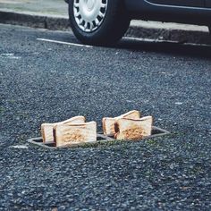 two pieces of wood sitting in the middle of a street