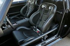 the interior of a car with black leather seats