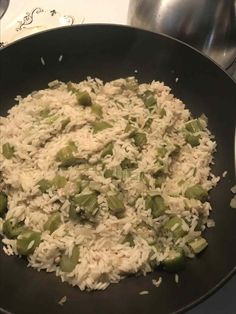 rice and peas are being cooked in a skillet