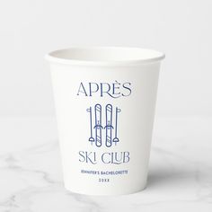 a white cup sitting on top of a marble counter