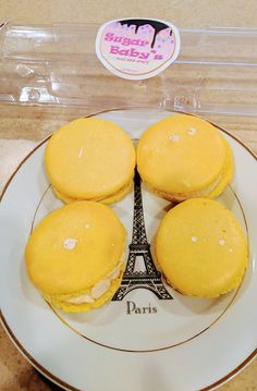 four pastries on a plate with the eiffel tower in the back ground