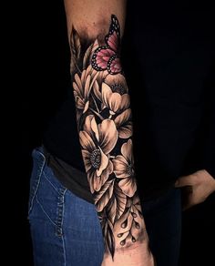 a woman's arm with flowers and a butterfly on it