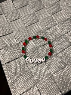 handmade italy beaded bracelet 🇮🇹. made with 4mm and 6mm bicone crystal gems and white letters on elastic string. message with any comments,questions, or concerns 🤍. Beaded Crafts, Bracelet Ideas, Seed Bead Bracelets, White Letters, Crystal Gems, Bead Bracelet, Seed Bead, Pearl Bracelet, Beaded Bracelet