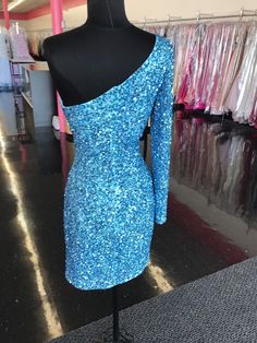 Ashley Lauren 4457 Cocktail Dress. This is a perfect homecoming or pageant dress, pick your color. The fitted dress is fully hand beaded sequins with one shoulder neckline and a sheer beaded long sleeve. This dress would make an excellent reception dress if you wanted sparkle at your wedding. Colors: Neon Blue Sizes: 8 Ashley Lauren, Blue Cocktails, Dress One Shoulder, Blue Cocktail Dress, Pageant Dress, Reception Dress, Neon Blue, Dress First, Fitted Dress