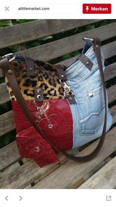 a purse is sitting on a bench with the bottom part of it in red and blue