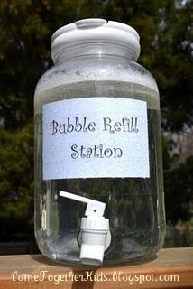 a glass jar with a white pump on it sitting on top of a wooden table