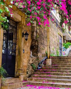 the stairs are covered with pink flowers