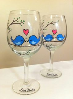 two wine glasses with blue birds painted on them