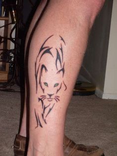 a cat tattoo on the leg of a man