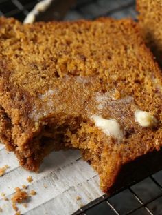 two pieces of cake sitting on top of a cooling rack next to another piece of bread