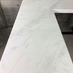 a white marble counter top in a bathroom