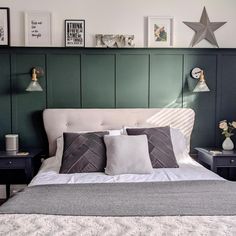 a bedroom with green paneled walls and white bedspread, two night stands on either side of the bed