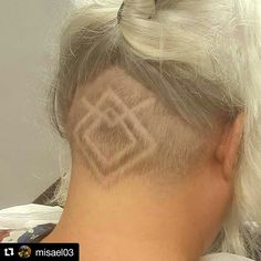 the back of a woman's head with an undercut on top of it