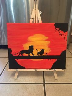 the lion king and cub painting on an easel