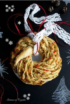 a homemade christmas wreath made with pasta and sprinkles on a black background