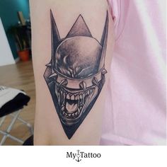 a person with a tattoo on their arm that has an image of a demon in it