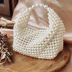 Discover the epitome of luxury in our Handmade Pearl Bag. Crafted with care, the intricate beauty of meticulously arranged beads comes together to form a truly exquisite accessory. Elevate your elegance with this luxurious piece that exudes charm and sophistication. Pearl Clutch Bag, Pearl Handbag, Hand Beaded Bag, Pearl Bag, Handcrafted Accessories, Jean Accessories, Beaded Bags, Hand Beading, Pearl Beads