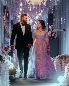 a man and woman walking down a runway