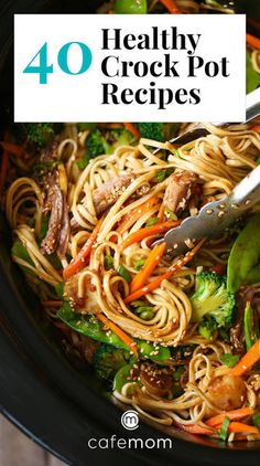 a pot filled with noodles, carrots and broccoli next to a fork