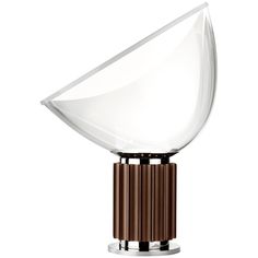 the modern table lamp has a glass shade on it's base and is brown