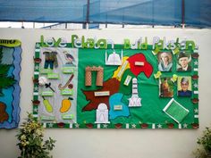 a green bulletin board with pictures and words on it in front of a white wall