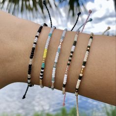 "TIFF&E waterproof bracelets and anklets are perfect for your active lifestyle - wear them anywhere... beach, pool, gym, shower, you name it! Alone or stacked with others, they give an effortless bohemian vibe and wearing them everyday will only enhance the natural look and feel. Each TIFF&E item is: -handmade with meticulous attention to detail using high quality waterproof waxed polyester string -adjustable using our unique minimalist sliding knot -super cute and fun when stacked with Beach Vibe Bracelet, Festival Tiny Beads Strand Bracelets, Festival Strand Bracelets With Tiny Beads, Black Beach Friendship Bracelets With Tiny Beads, Minimalist Adjustable Beaded Bracelets For Beach, Minimalist Adjustable Anklets For Beach, Casual Beaded Strand Bracelets For Festivals, Minimalist Black Beaded Bracelets For Beach, Casual Strand Beaded Bracelets For Festivals