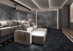 a room that has some couches and a projector screen on the wall in front of it