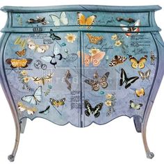 a blue cabinet with butterflies painted on the doors and drawers, all in different colors