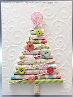 a christmas tree made out of fabric and buttons on a white card with a pink umbrella in the background